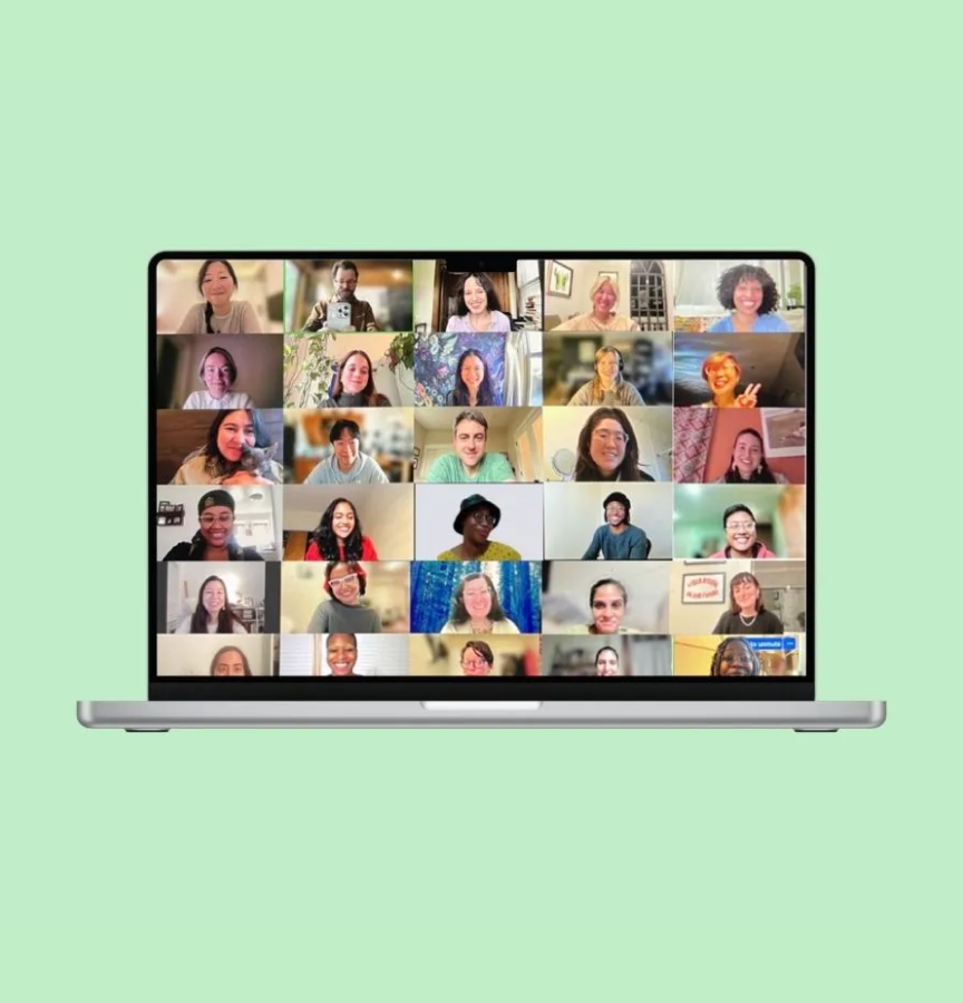 a laptop displaying 30 individuals on a video conference call posing for a photo